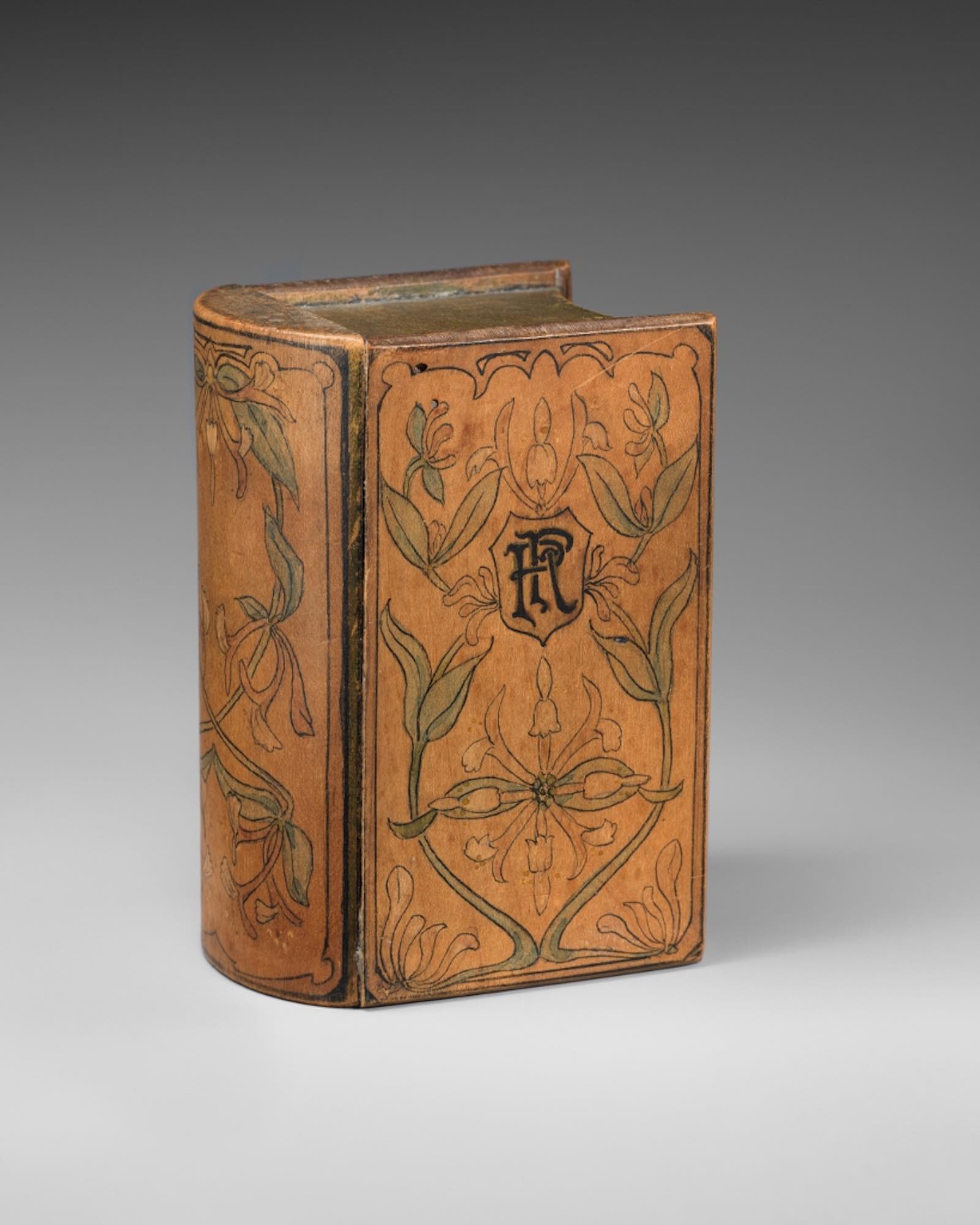 Maker unknown, art nouveau style three-drawer chest in book form, English, 19th – 20th centur, wood (maple), penwork, paint. 12.0 x 8.5 x 6.6 cm. Gift of Lynn and Bruce Heckman, 2024